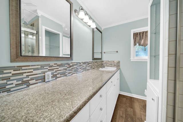 bathroom with decorative backsplash, hardwood / wood-style floors, vanity, ornamental molding, and toilet