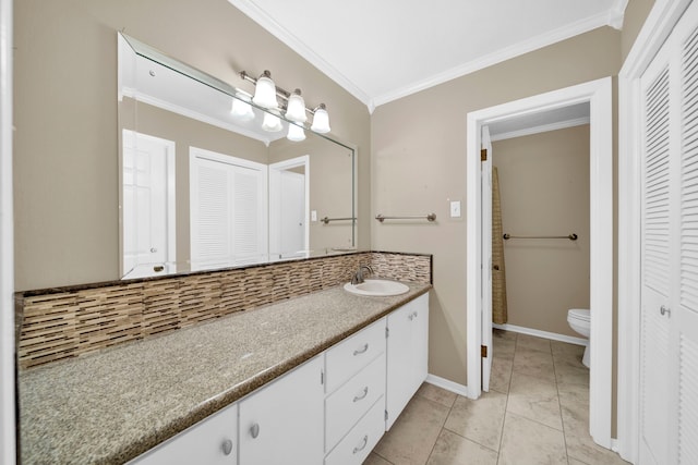 bathroom featuring backsplash, ornamental molding, vanity, and toilet