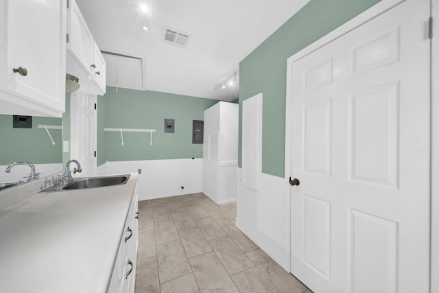 laundry room featuring track lighting, sink, and light tile patterned flooring