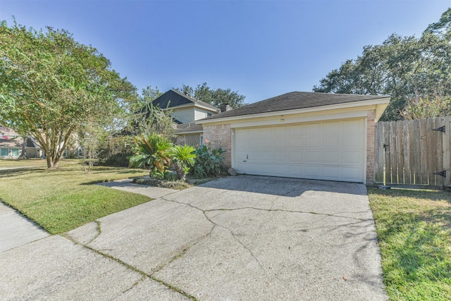 view of front of house with a garage, fence, a front lawn, and brick siding