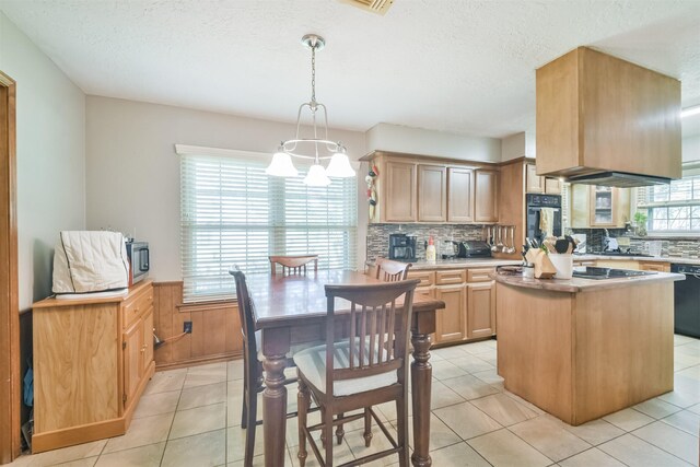 kitchen with decorative backsplash, a kitchen island, a wealth of natural light, and black appliances