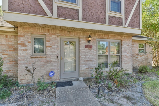 doorway to property with brick siding