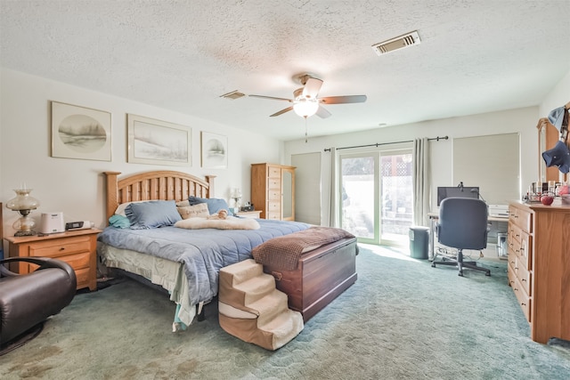 carpeted bedroom with ceiling fan, a textured ceiling, visible vents, and access to exterior