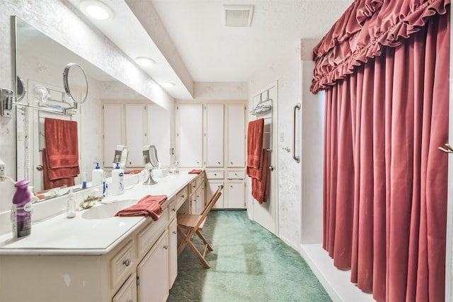 bathroom with a textured ceiling and vanity