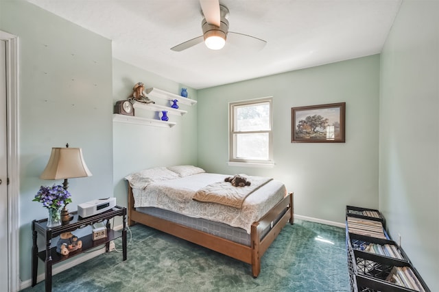 bedroom with ceiling fan, dark carpet, and baseboards