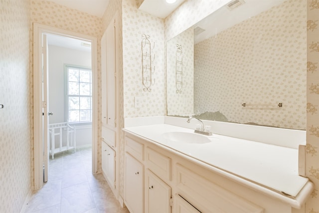 bathroom featuring tile patterned floors, visible vents, vanity, and wallpapered walls