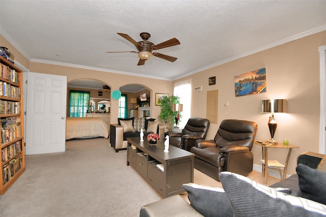 living room featuring light carpet, crown molding, a textured ceiling, and ceiling fan