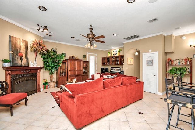 living room featuring crown molding, light tile patterned floors, and ceiling fan