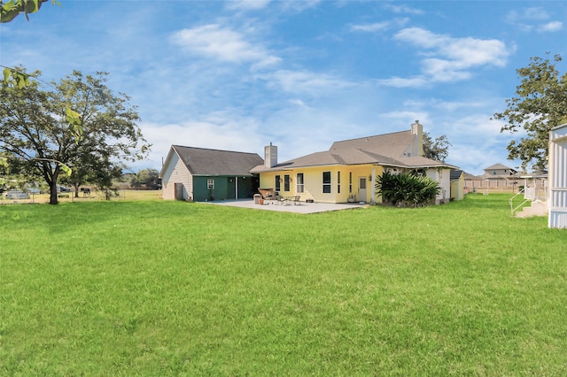 rear view of property featuring a patio and a lawn