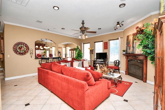 tiled living room with ornamental molding and ceiling fan with notable chandelier