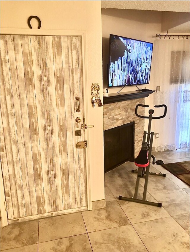 3600 Jeanetta St Unit 502, Houston, TX 77063 - exercise area featuring tile patterned flooring and a textured ceiling