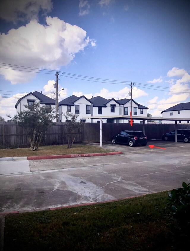 3600 Jeanetta St Unit 502, Houston, TX 77063 - partially covered parking lot with fence and a residential view