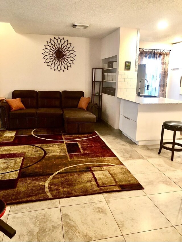 3600 Jeanetta St Unit 502, Houston, TX 77063 - living room featuring a textured ceiling