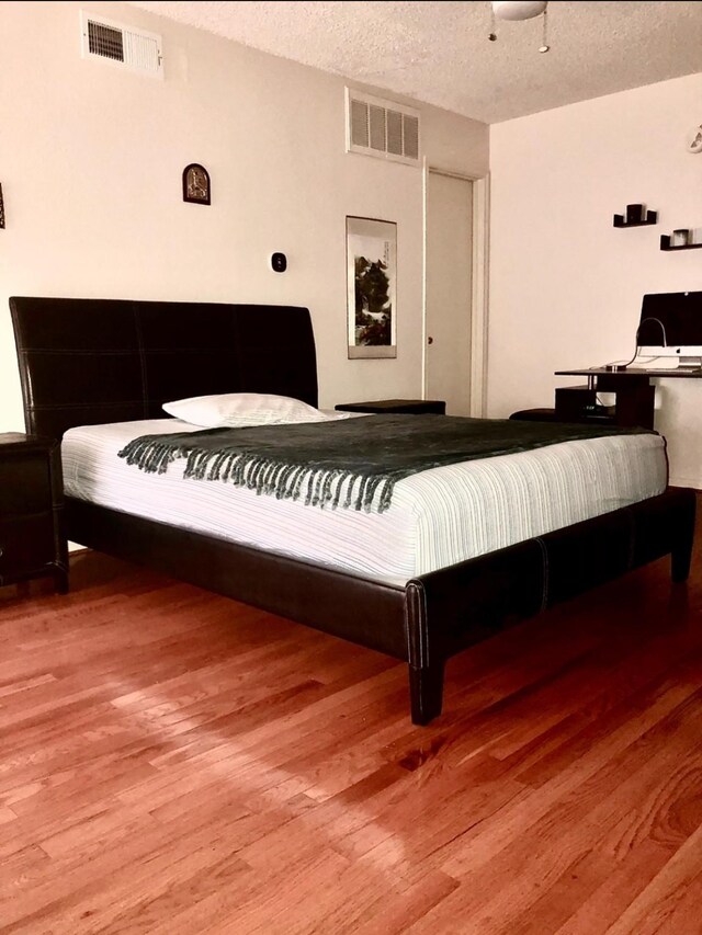 3600 Jeanetta St Unit 502, Houston, TX 77063 - bedroom with wood finished floors and a textured ceiling