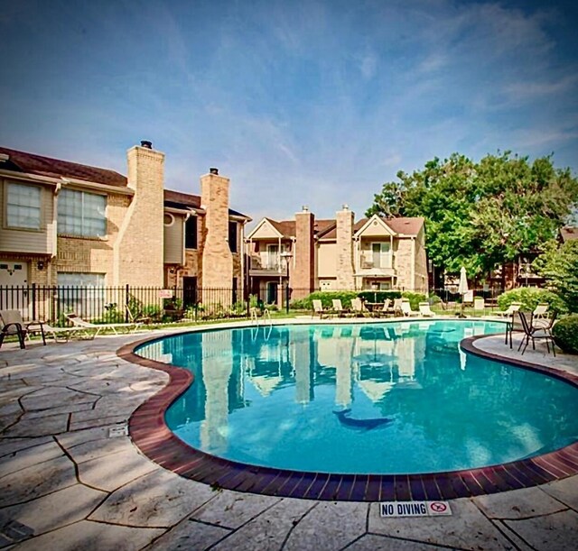3600 Jeanetta St Unit 502, Houston, TX 77063 - community pool with fence, a patio, and a residential view