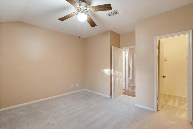 unfurnished bedroom featuring ensuite bath, ceiling fan, and light colored carpet