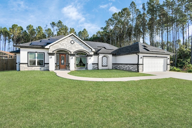 view of front of home with solar panels, a front yard, and a garage