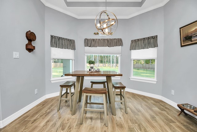 dining room featuring ornamental molding, a chandelier, and light hardwood / wood-style floors