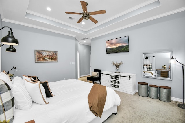 carpeted bedroom featuring crown molding, ceiling fan, and a raised ceiling