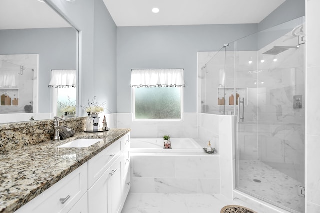 bathroom featuring separate shower and tub and vanity