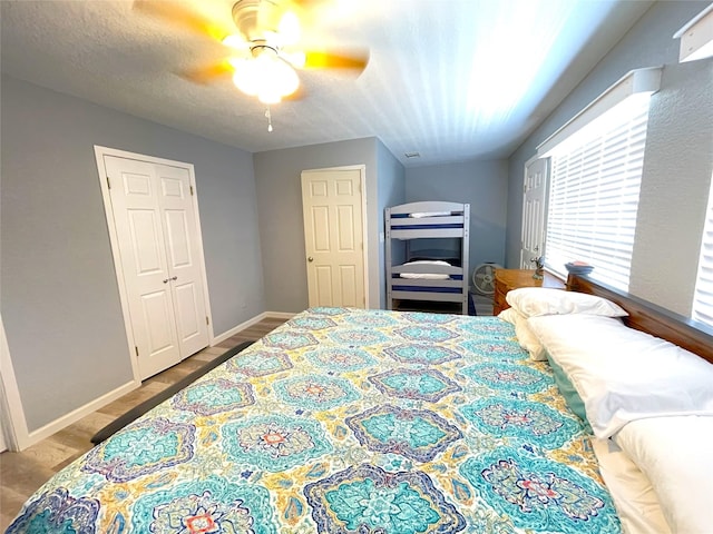 2619 Swan Ct, Surfside Beach, TX 77541 - bedroom with multiple windows, ceiling fan, and wood finished floors