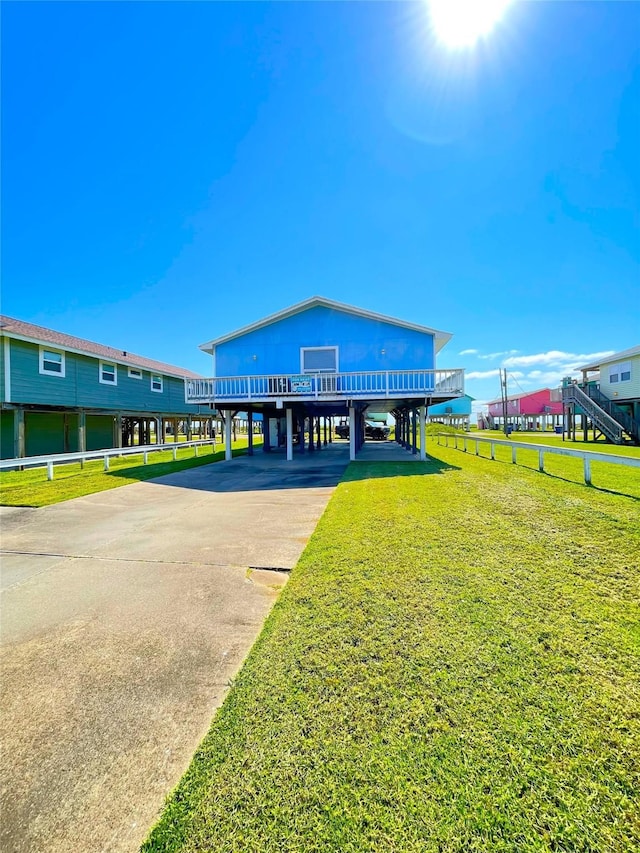 2619 Swan Ct, Surfside Beach, TX 77541 - view of community with a carport, a lawn, and driveway