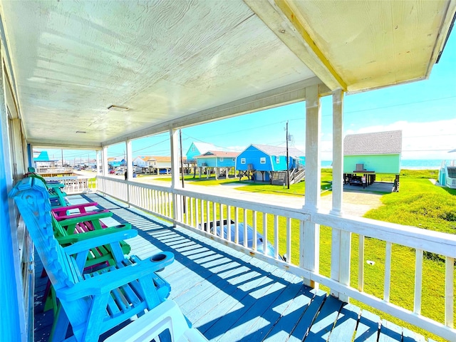 wooden deck featuring a yard