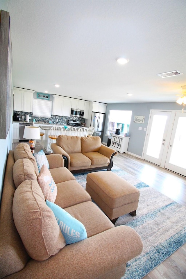 2619 Swan Ct, Surfside Beach, TX 77541 - living room featuring light wood-style flooring and recessed lighting