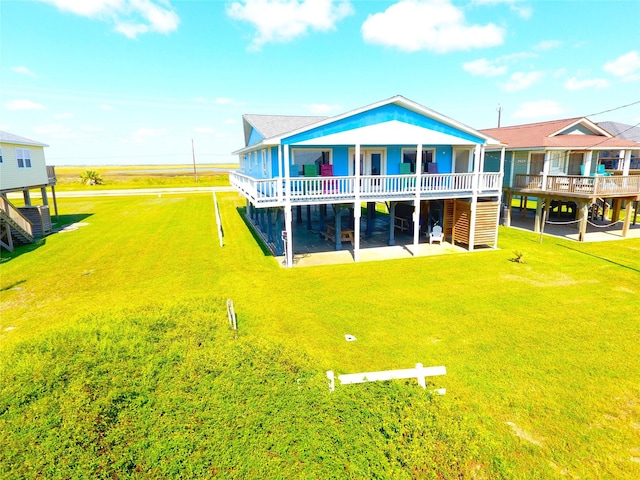 2619 Swan Ct, Surfside Beach, TX 77541 - back of house with stairway, a wooden deck, and a lawn