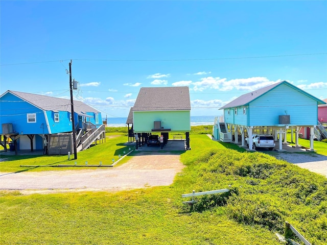 2619 Swan Ct, Surfside Beach, TX 77541 - view of green lawn with a carport and driveway