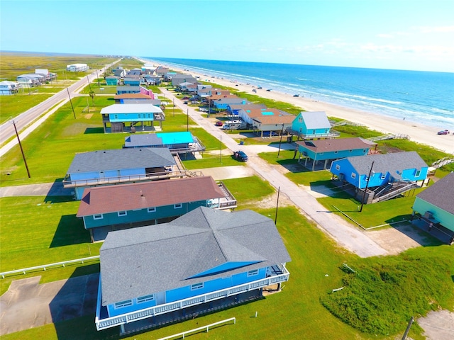 drone / aerial view with a water view and a view of the beach