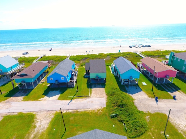 birds eye view of property featuring a water view and a beach view