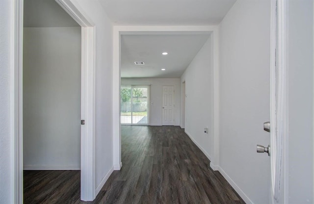 corridor with dark hardwood / wood-style flooring