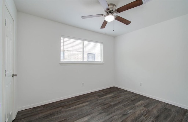 spare room with dark wood-type flooring and ceiling fan