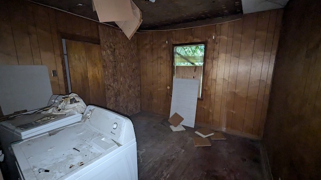 clothes washing area with wooden walls, dark hardwood / wood-style floors, and washing machine and dryer