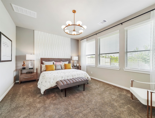 carpeted bedroom featuring a notable chandelier