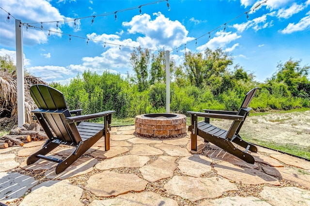 1052 Johnson Rd, Gilchrist, TX 77617 - view of patio featuring an outdoor fire pit
