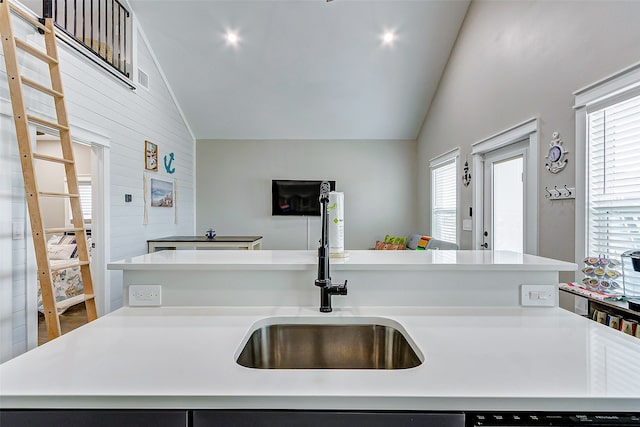 kitchen featuring a center island with sink, lofted ceiling, and sink