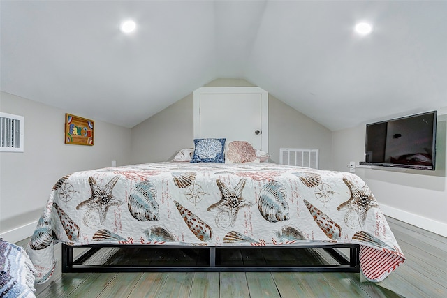 bedroom featuring wood-type flooring and vaulted ceiling