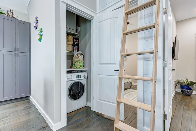 washroom with washer / dryer and dark hardwood / wood-style flooring