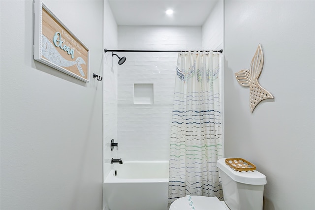 bathroom featuring shower / tub combo and toilet