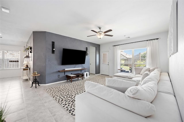 living room with light tile patterned floors and ceiling fan