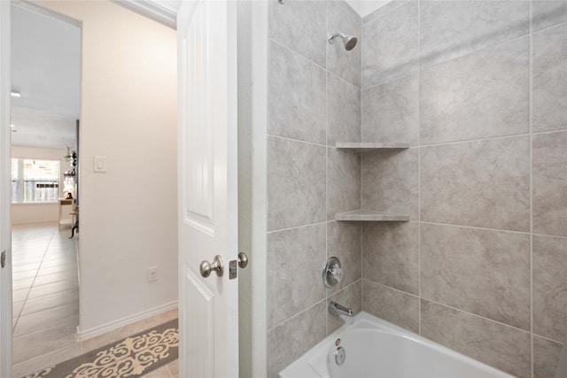 bathroom with tile patterned floors and tiled shower / bath