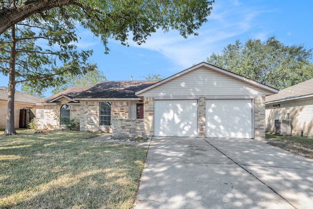 ranch-style home with cooling unit, a front yard, and a garage