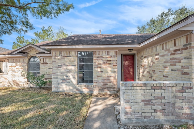 entrance to property with a lawn