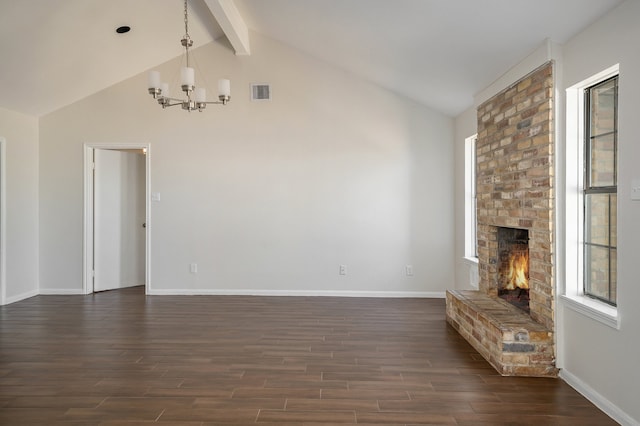 unfurnished living room with dark wood-type flooring, high vaulted ceiling, a fireplace, beam ceiling, and a chandelier