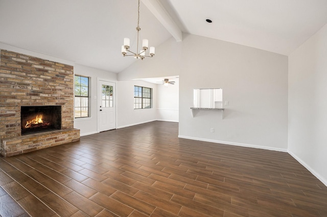 unfurnished living room with beamed ceiling, a large fireplace, ceiling fan with notable chandelier, and dark hardwood / wood-style floors