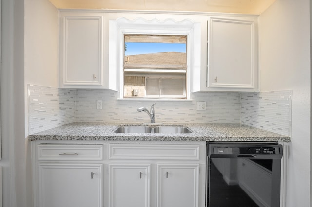 kitchen featuring light stone countertops, black dishwasher, white cabinetry, and sink