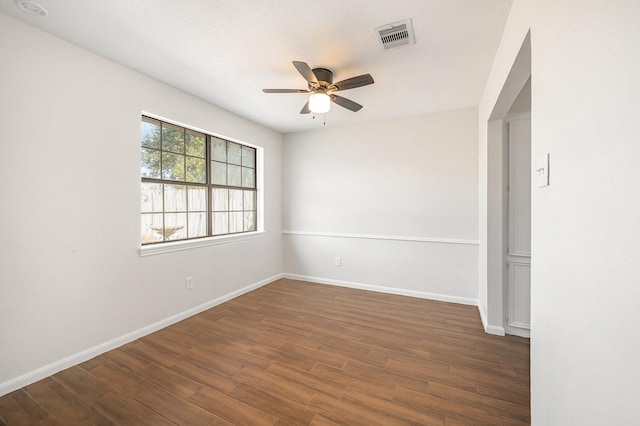 spare room featuring dark hardwood / wood-style flooring and ceiling fan