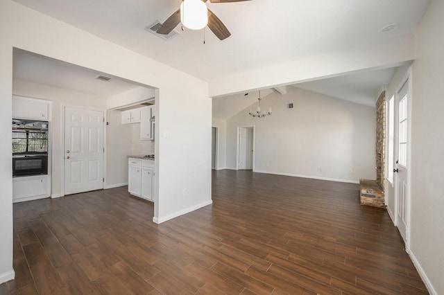 unfurnished living room featuring ceiling fan with notable chandelier, lofted ceiling with beams, and dark hardwood / wood-style floors